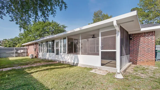 a view of a house with backyard and sitting area