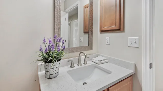a bathroom with a sink a vanity and a mirror