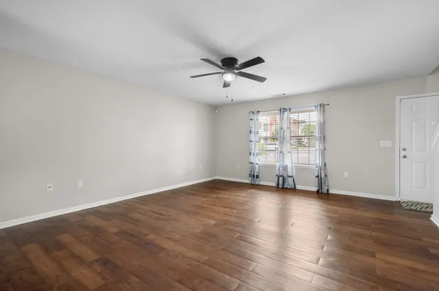 wooden floor in an empty room with a window