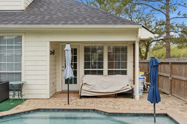 an aerial view of residential houses with outdoor space and trees