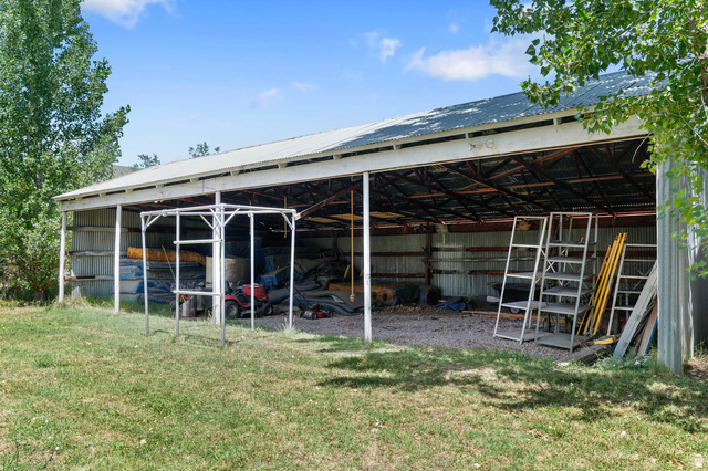 1489 North 400 West Bountiful, UT 84010 - Photo 36 of 47 Expansive open-sided barn featuring a metal roof, exposed structural beams, and corrugated metal siding
