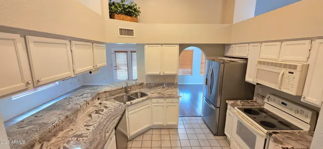 a kitchen with a refrigerator and a stove