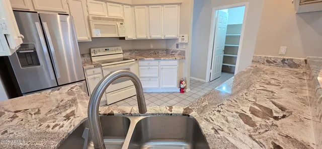 a stove top oven sitting inside of a kitchen