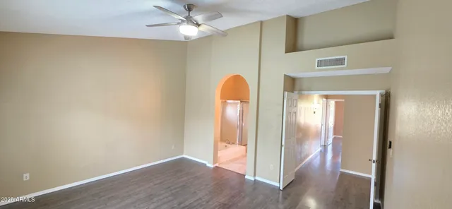 a view of a room with wooden floor and a chandelier