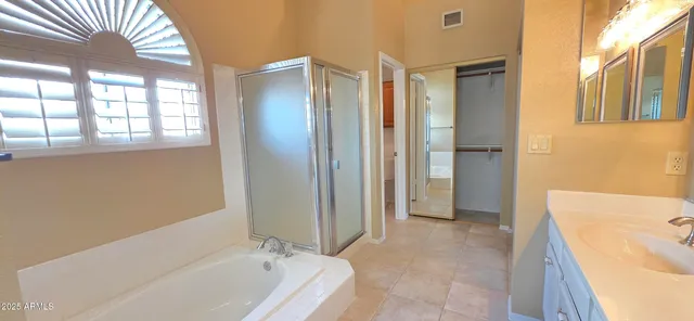 a bathroom with a double vanity sink and a window