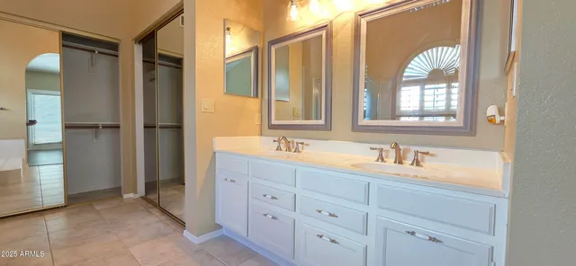 a bathroom with a glass shower door and a sink