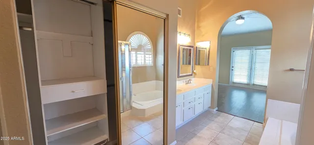a bathroom with a double vanity sink and a mirror