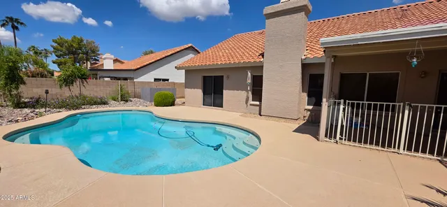 a view of a swimming pool with an outdoor seating and a potted plant