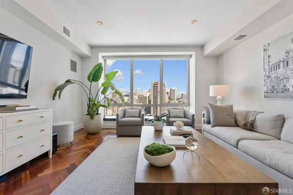 a living room with furniture and a wooden floor