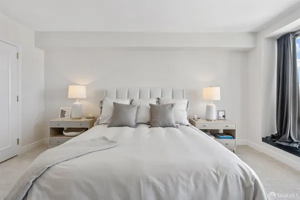 a bedroom with a bed and a potted plant
