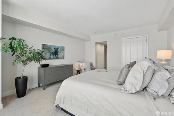 a bedroom with a bed and chair