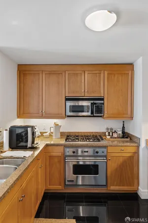 a kitchen with a sink stove and microwave