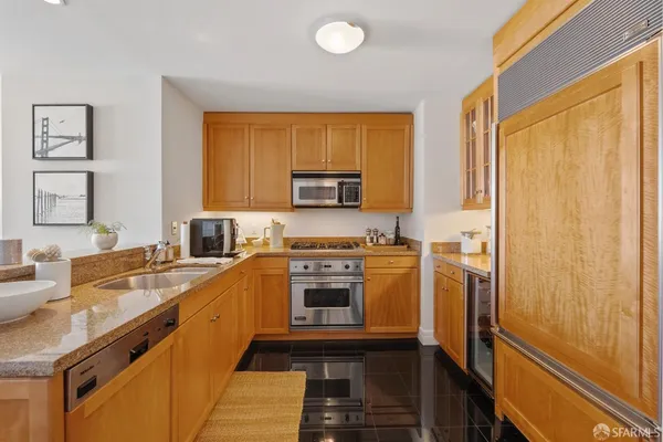 a kitchen with a refrigerator stove and sink