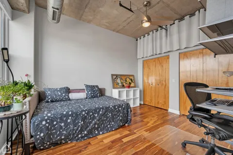 a bedroom with a bed and a desk