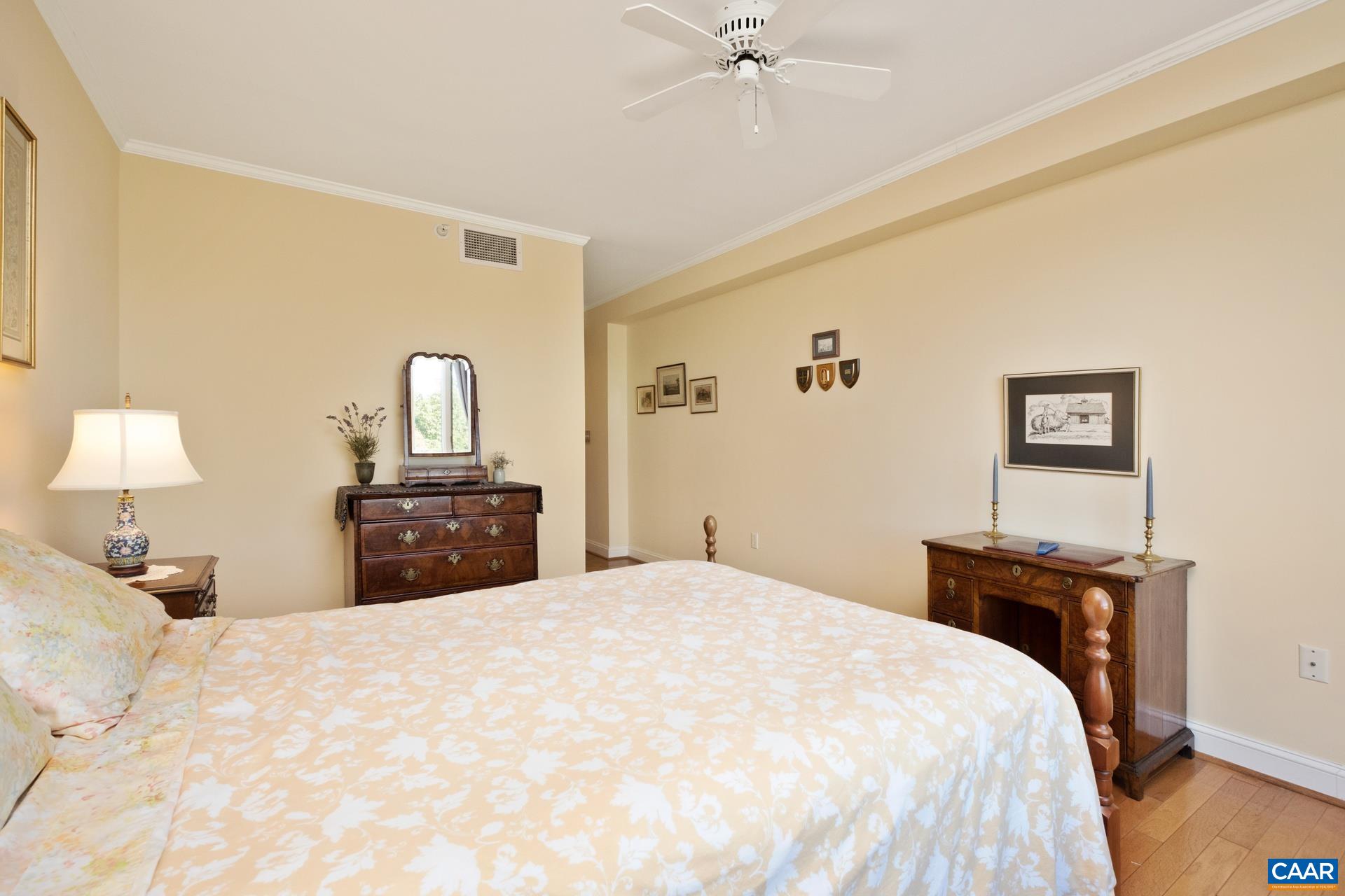 500 Crestwood Drive, Unit 1305 Charlottesville, VA 22903 - Photo 18 of 32 a bedroom with a bed and a lamp