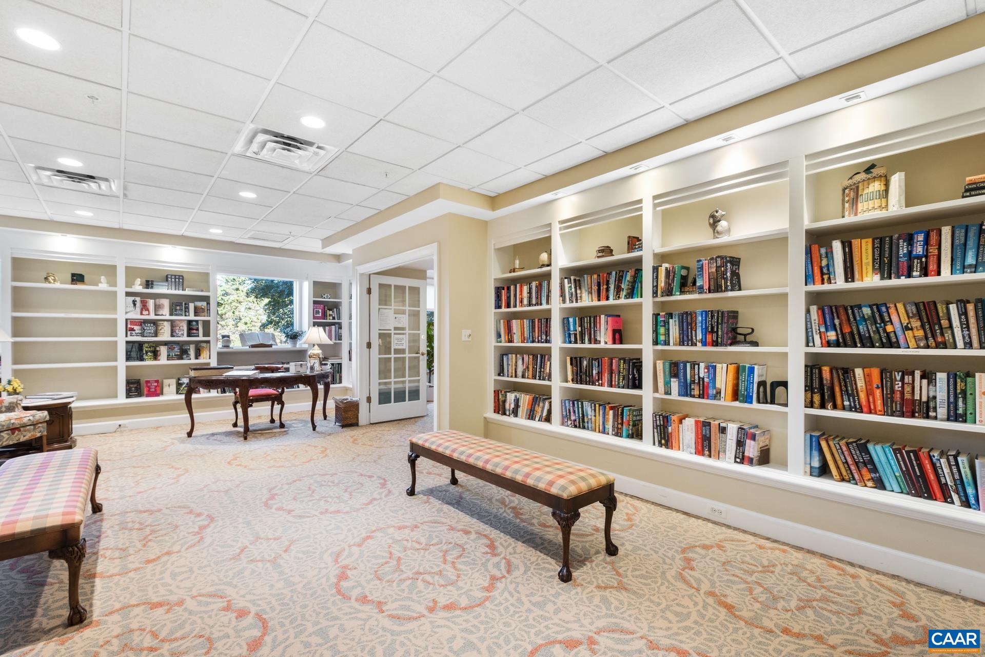 500 Crestwood Drive, Unit 1305 Charlottesville, VA 22903 - Photo 27 of 32 a living room with furniture and a book shelf