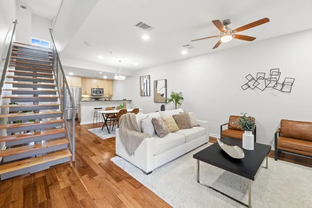 a living room with furniture and kitchen view