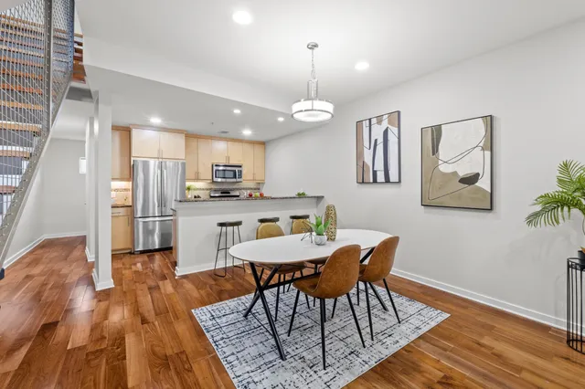 a view of a dining room with furniture wooden floor and chandelier