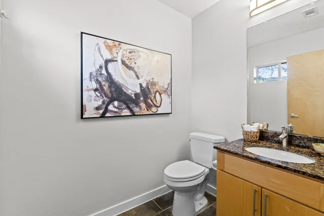 a bathroom with a toilet a sink and mirror