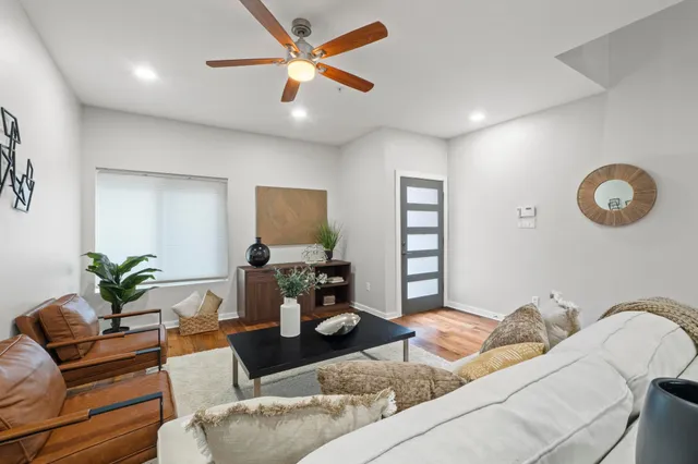 a living room with furniture a couch and a potted plant