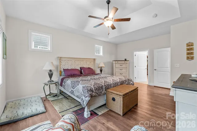 a spacious bathroom with a double vanity sink a large mirror and a shower