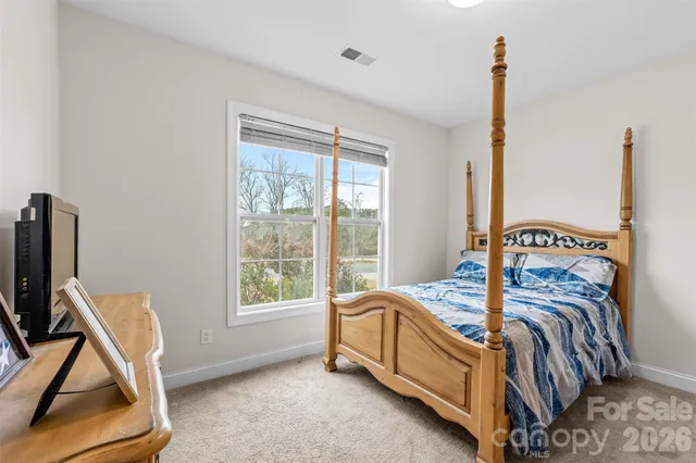 a view of a dining room and livingroom with furniture wooden floor a chandelier