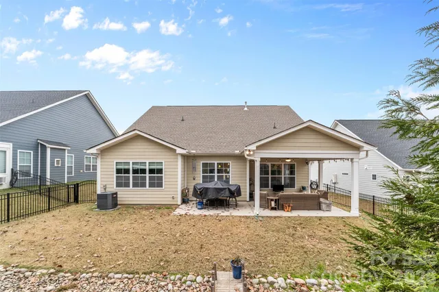a front view of a house with a yard outdoor seating and garage