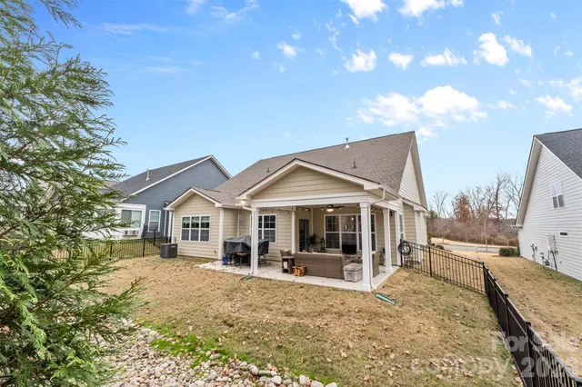 an aerial view of a house with a yard and lake view