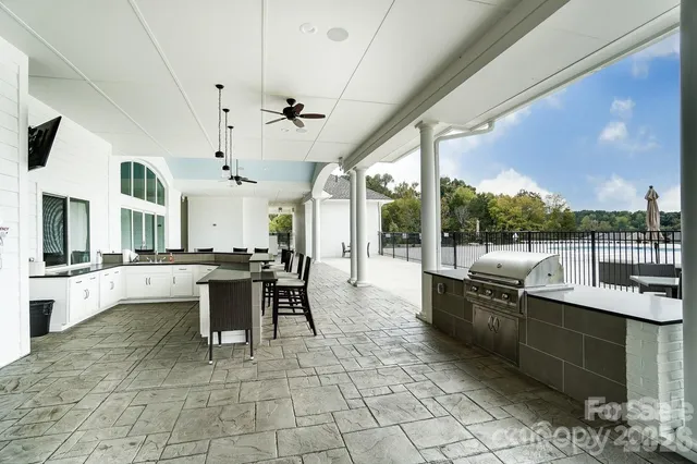 a view of a livingroom with furniture staircase and a large window