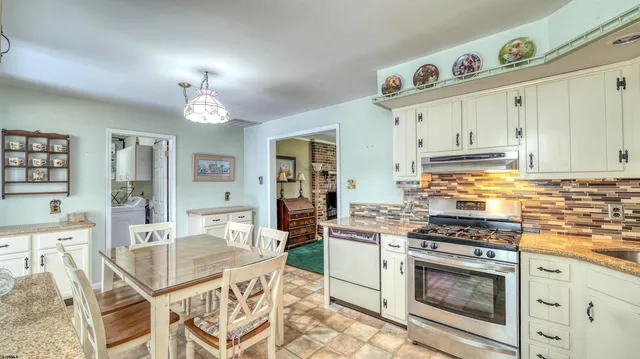 a kitchen with a stove a sink and a refrigerator