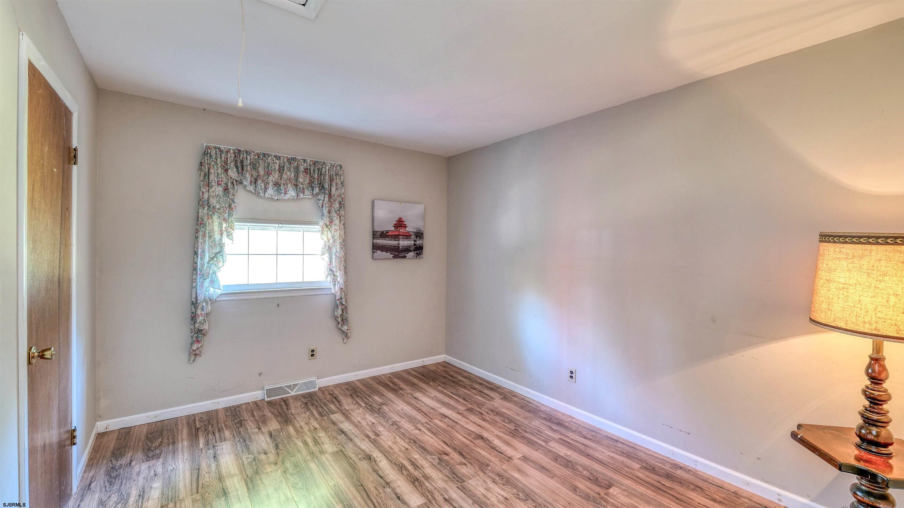 212 East Upland Avenue Galloway Township, NJ 08205 - Photo 15 of 37 a view of empty room with wooden floor and fan