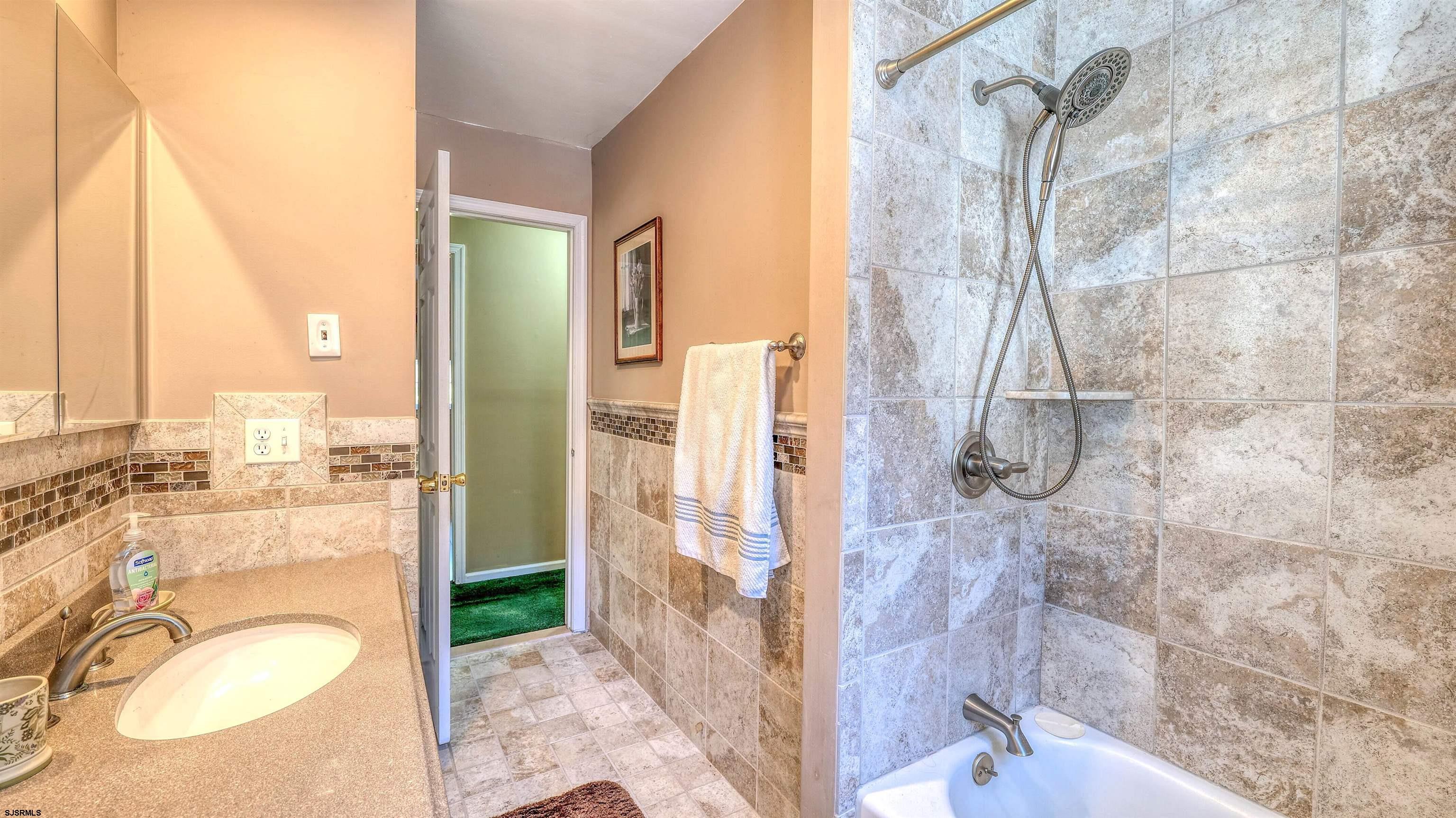 212 East Upland Avenue Galloway Township, NJ 08205 - Photo 18 of 37 a bathroom with a granite countertop sink a mirror and a shower