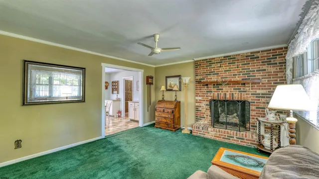 a living room with fireplace furniture and a window