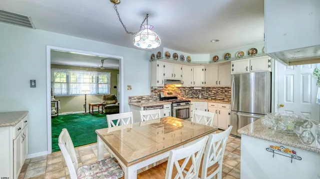 a kitchen with a table and chairs in it