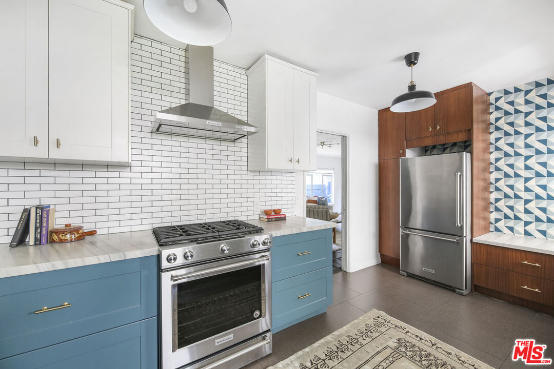 2145 Griffith Park Boulevard Los Angeles, CA 90039 - Photo 13 of 38 a kitchen with granite countertop a stainless steel stove and refrigerator