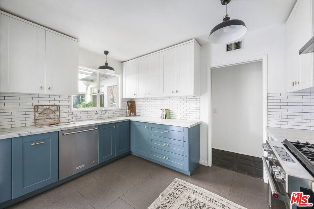 2145 Griffith Park Boulevard Los Angeles, CA 90039 - Photo 14 of 38 a kitchen with granite countertop a sink stainless steel appliances and cabinets