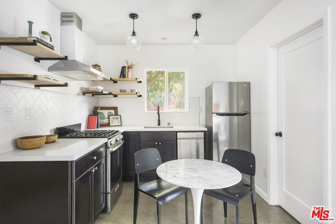 2145 Griffith Park Boulevard Los Angeles, CA 90039 - Photo 33 of 38 a kitchen with a table chairs stove and refrigerator