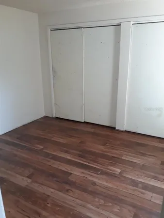 a view of a room with wooden floor