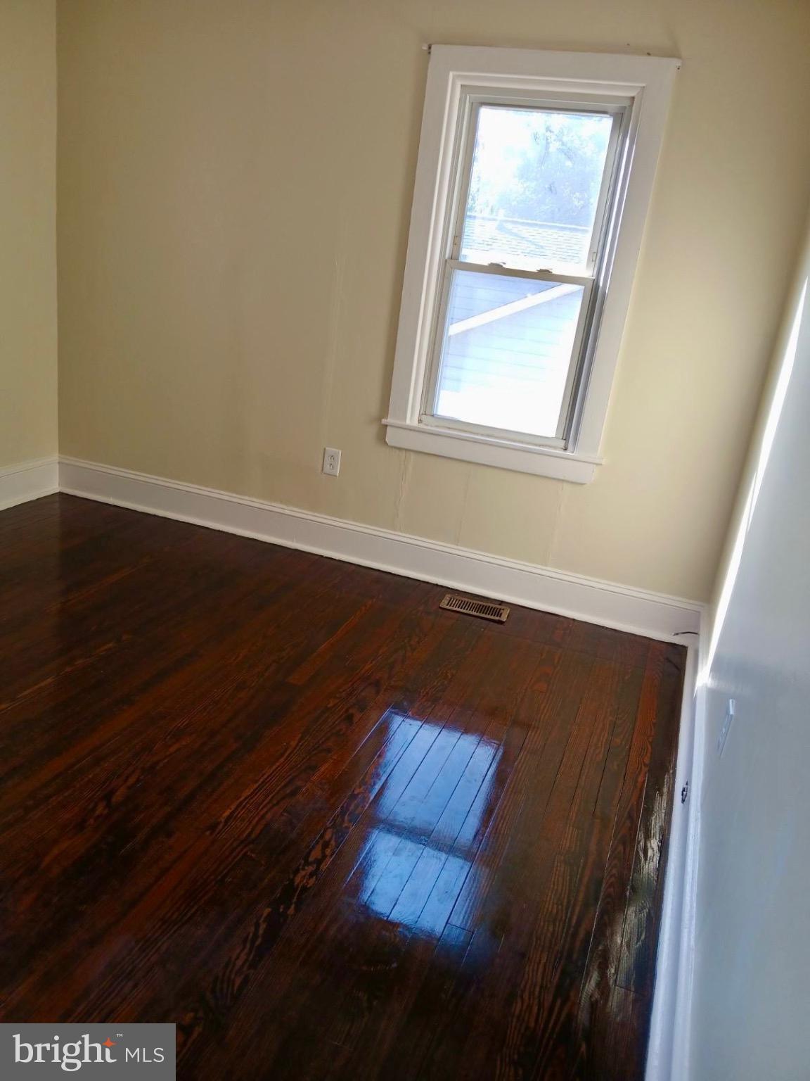 1755 Rockwell Road Abington, PA 19001 - Photo 12 of 19 an empty room with wooden floor and windows