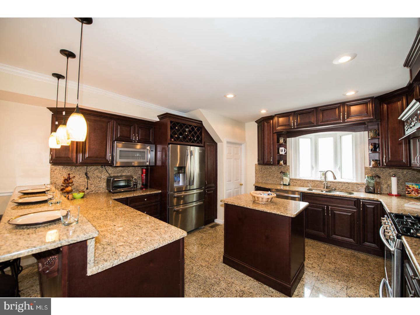 1755 Rockwell Road Abington, PA 19001 - Photo 5 of 19 a kitchen with kitchen island a sink appliances and cabinets