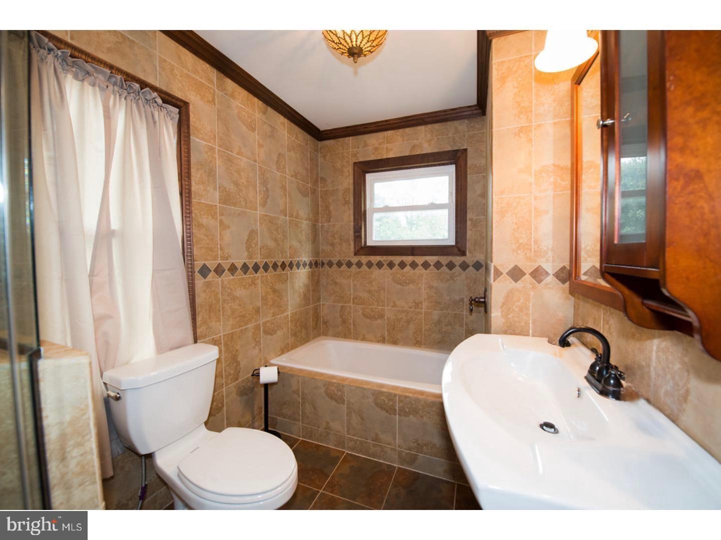 1755 Rockwell Road Abington, PA 19001 - Photo 9 of 19 a bathroom with a sink toilet and shower