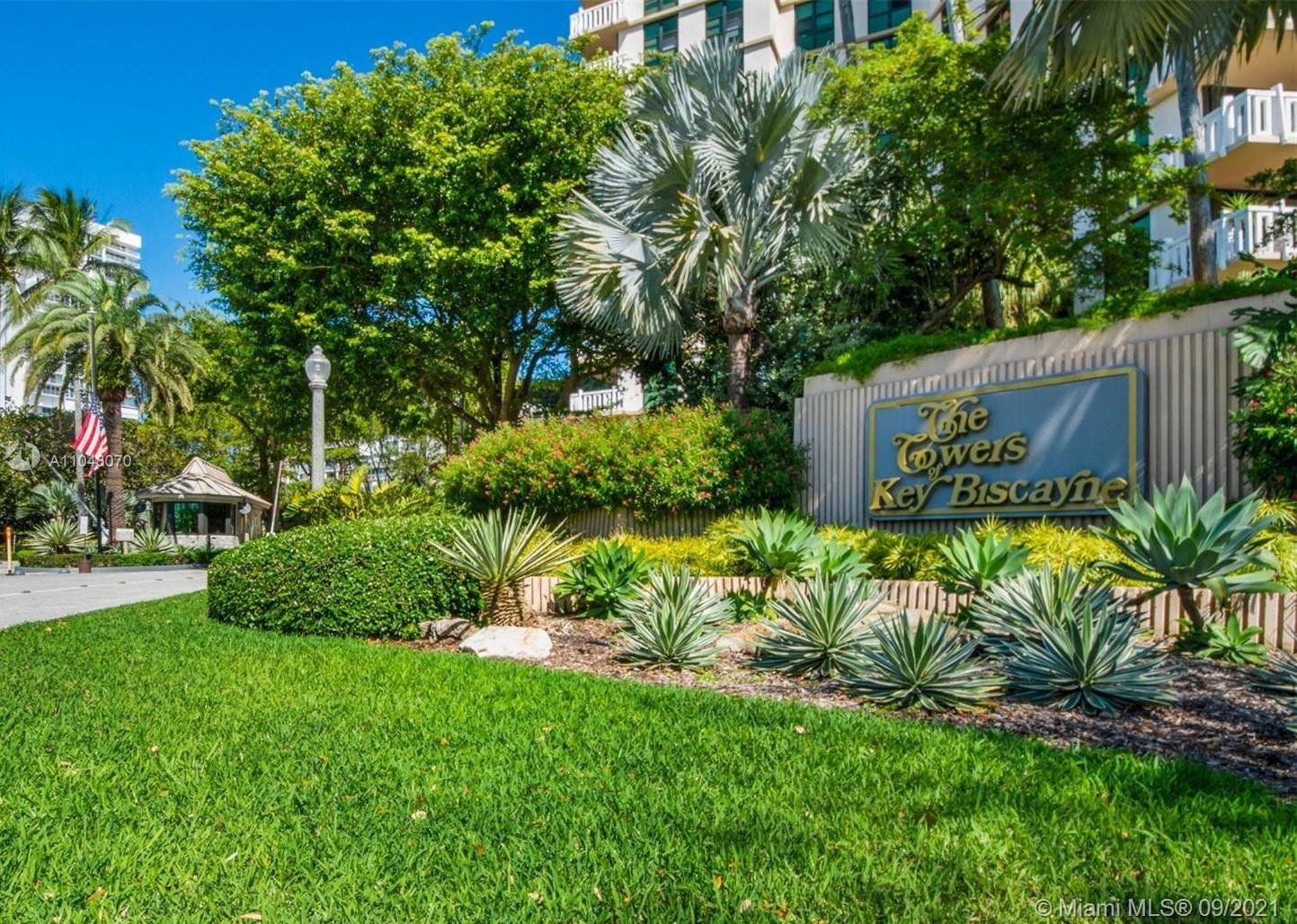 1121 Crandon Boulevard, Unit D404 Key Biscayne, FL 33149 - Photo 1 of 27 a view of a garden with a building in the background