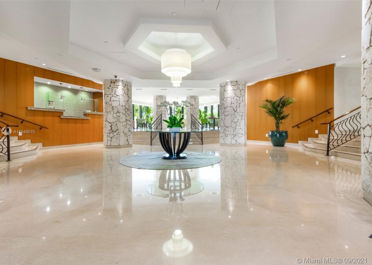 1121 Crandon Boulevard, Unit D404 Key Biscayne, FL 33149 - Photo 15 of 27 a view of a dining room with furniture wooden floor and chandelier