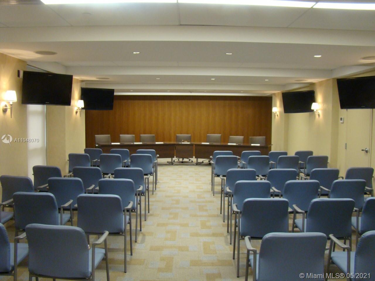 1121 Crandon Boulevard, Unit D404 Key Biscayne, FL 33149 - Photo 17 of 27 a media room with lots of chairs and a projector screen