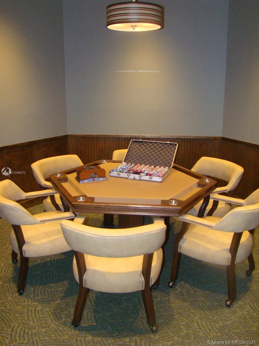 1121 Crandon Boulevard, Unit D404 Key Biscayne, FL 33149 - Photo 18 of 27 a table and chairs in a room