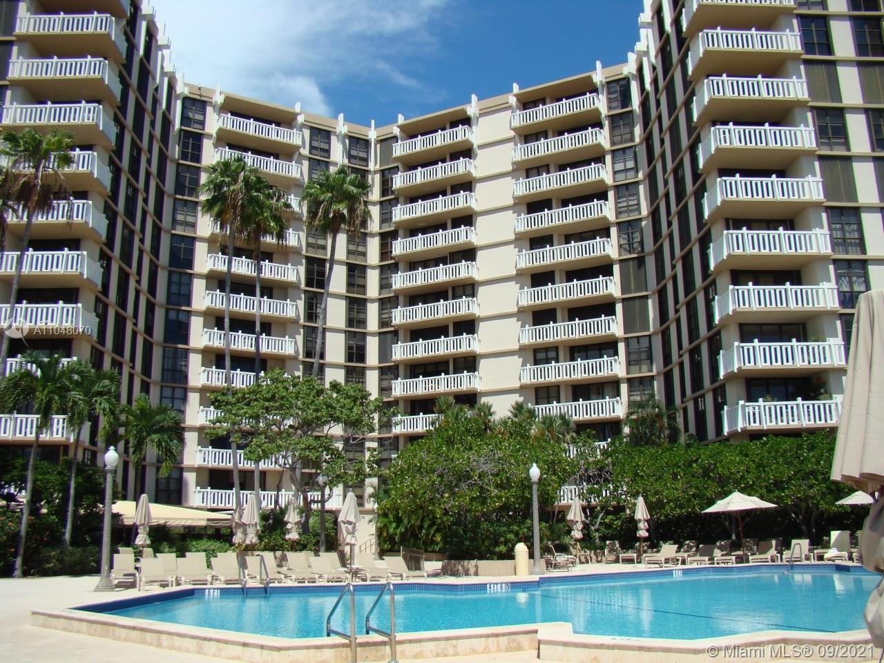 1121 Crandon Boulevard, Unit D404 Key Biscayne, FL 33149 - Photo 21 of 27 front view of building with yard