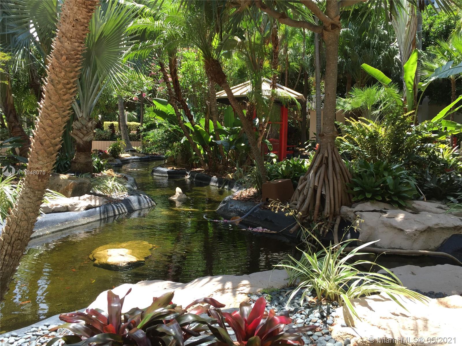 1121 Crandon Boulevard, Unit D404 Key Biscayne, FL 33149 - Photo 22 of 27 a view of swimming pool with a yard