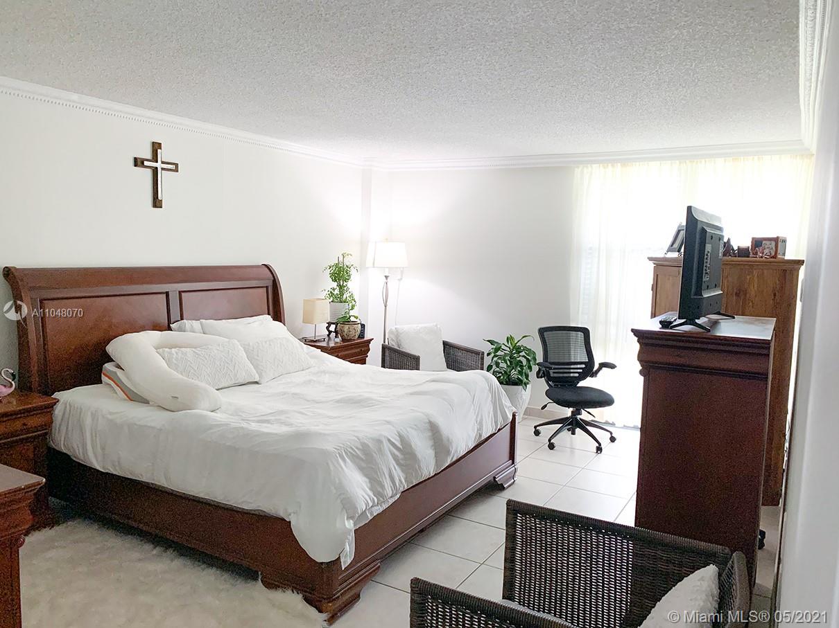 1121 Crandon Boulevard, Unit D404 Key Biscayne, FL 33149 - Photo 4 of 27 a bedroom with a bed and a desk