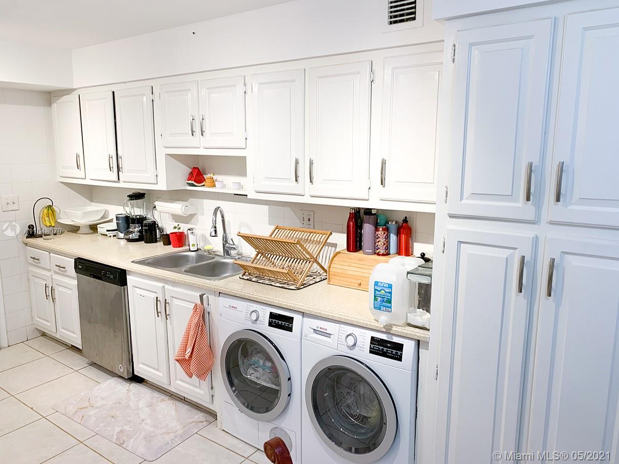 1121 Crandon Boulevard, Unit D404 Key Biscayne, FL 33149 - Photo 8 of 27 a utility room with sink dryer and washer