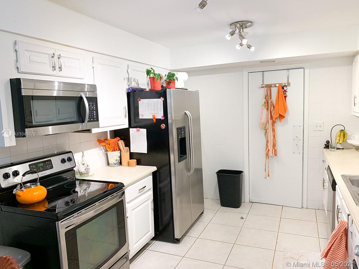 1121 Crandon Boulevard, Unit D404 Key Biscayne, FL 33149 - Photo 9 of 27 a kitchen with stainless steel appliances granite countertop a refrigerator and a stove top oven